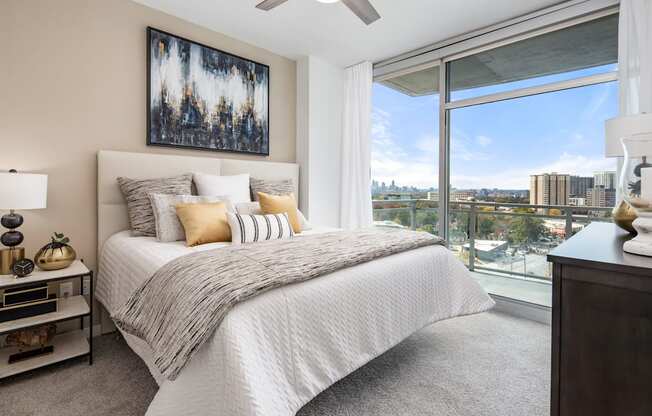 a bedroom with a bed and a view of the city