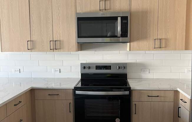 a kitchen with a stove and a microwave