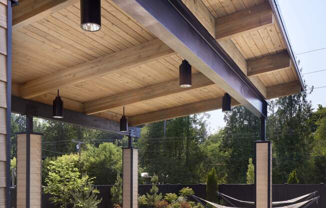 a covered patio with a hot tub and a pergola