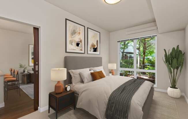 a bedroom with a large window and a large bed