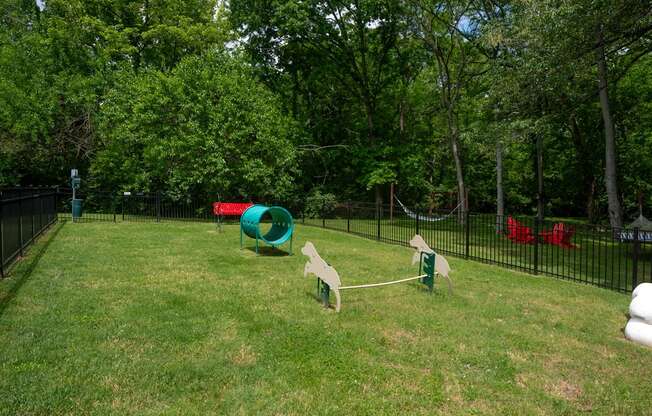 A pet park with a green slide and a red slide at The Retreat at Indian Lakes Apartments in Hendersonville TN.