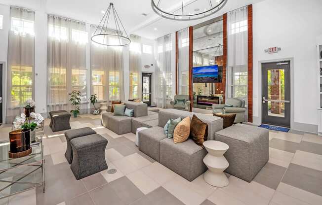 a lobby with couches and chairs and a glass door