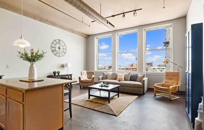 a living room with a couch and a table and a large window