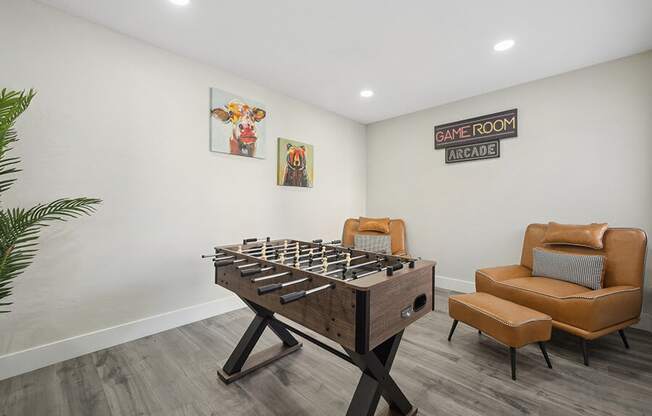 Community Clubhouse with Game Tables and Lounge Furniture at Villages at Metro Center Apartment located in Phoenix, AZ.