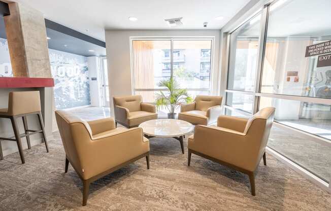 a lounge area with chairs and a coffee table