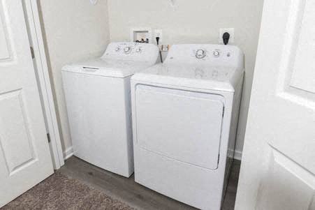 two white washers and dryers in a white room