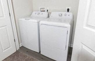 two white washers and dryers in a white room