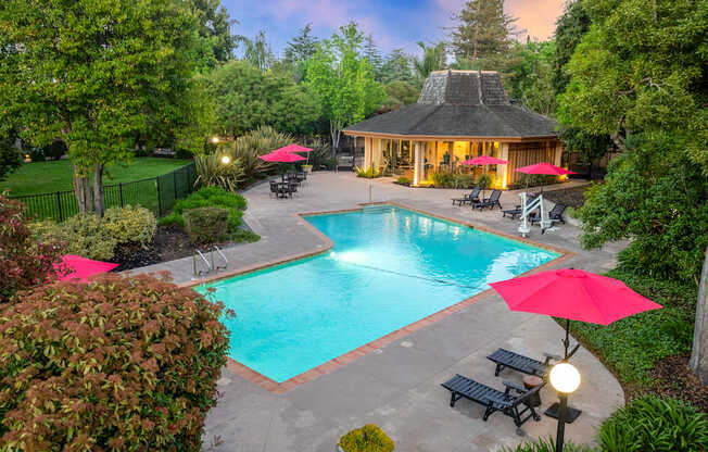 A backyard with a pool and a gazebo.