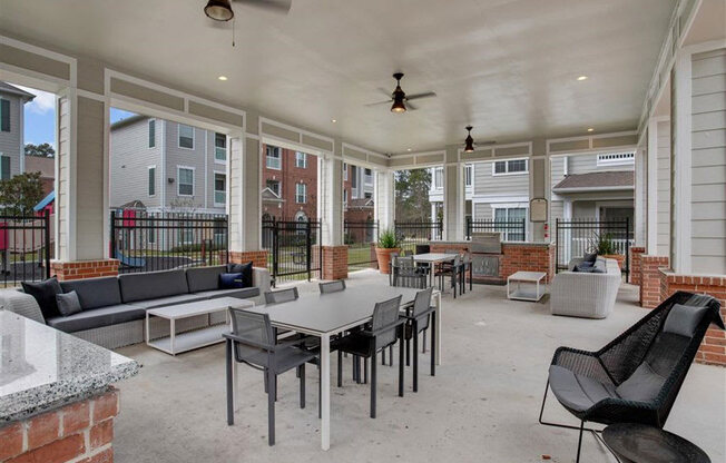 a large patio with tables and chairs at Volare at the Woodlands, The Woodlands, 77384