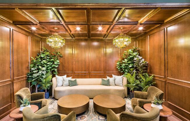 Parlor lounge with rich wood paneling, layered seating, and statement lighting creating a warm setting for conversation and quiet moments.