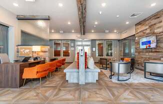 A modern living room with a stone wall and a TV.