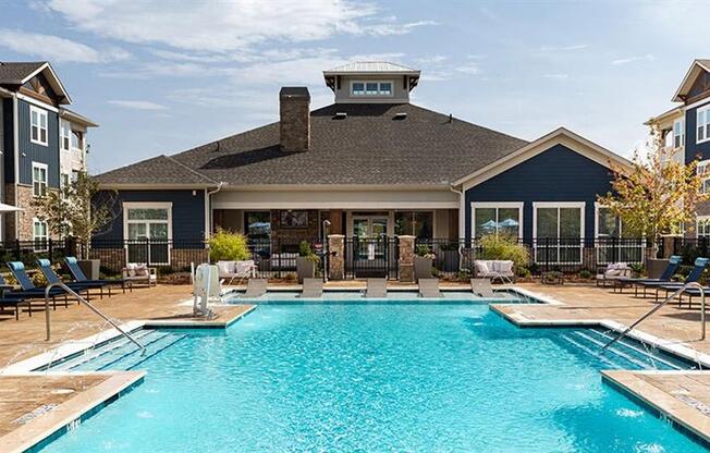 a swimming pool in front of a house at Promenade at Newnan Crossing, Newnan, GA