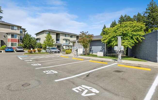 A parking lot with a bicycle rack and numbered parking spaces.