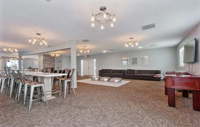 a game room with a pool table and a bar with chairs at Eastwood Crossings, Kansas City, MO, 64129