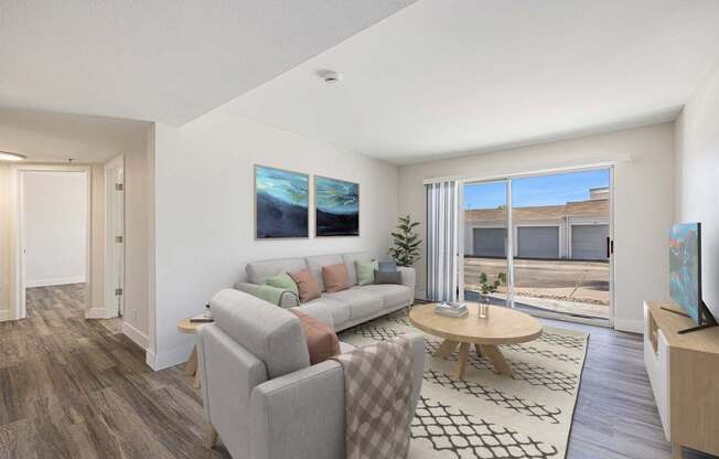 A living room with a grey couch and a wooden coffee table.