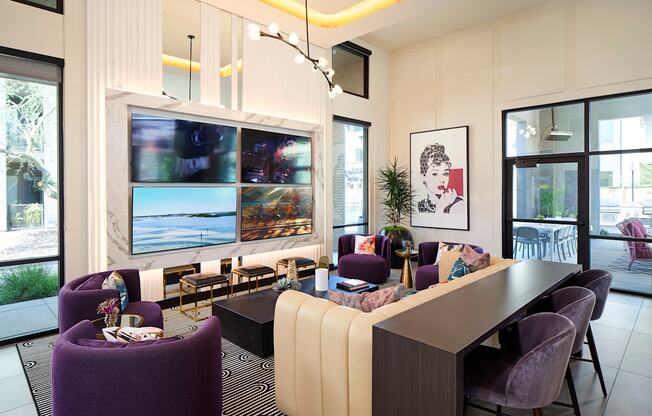 a living room with purple chairs and a table