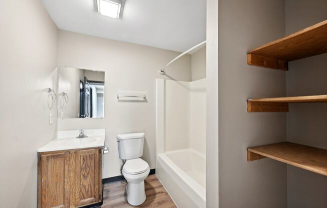 a bathroom with a toilet and a shower and a sink