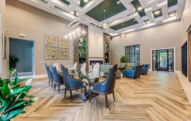 A dining room with a wooden floor and a glass table.