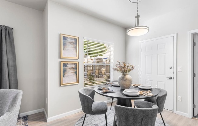 a dining room with a table and chairs