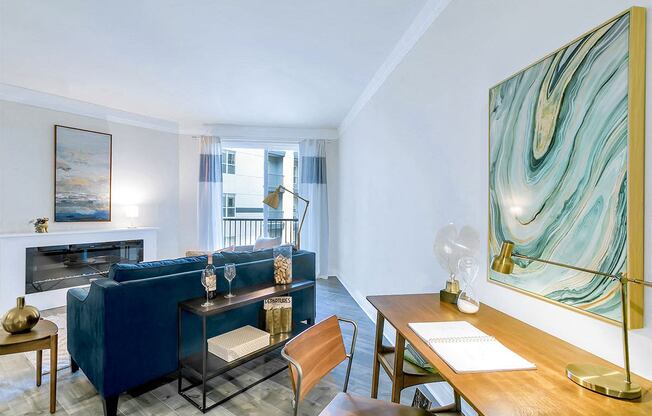 a living room with a blue couch and a fireplace at Aster Apartments, Ohio