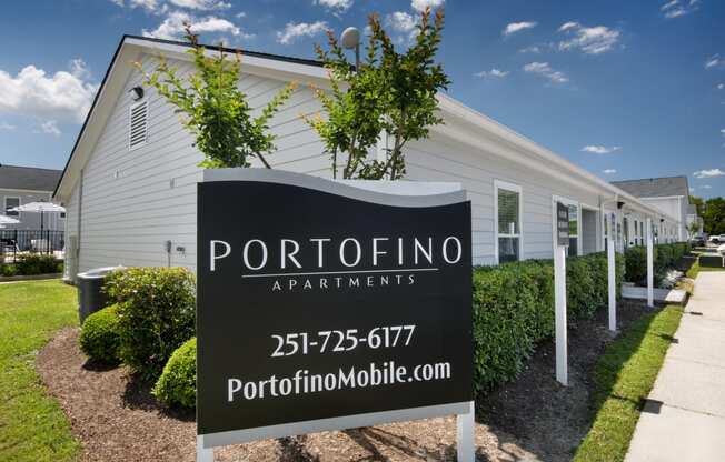 a white building with a sign apartments