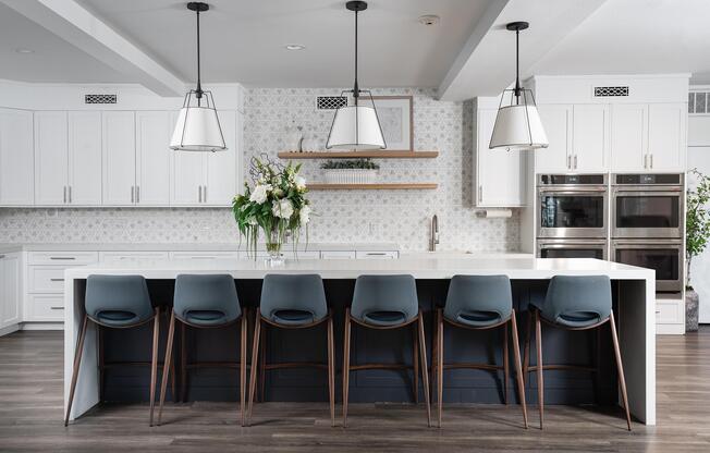 a kitchen with a table and chairs in a room