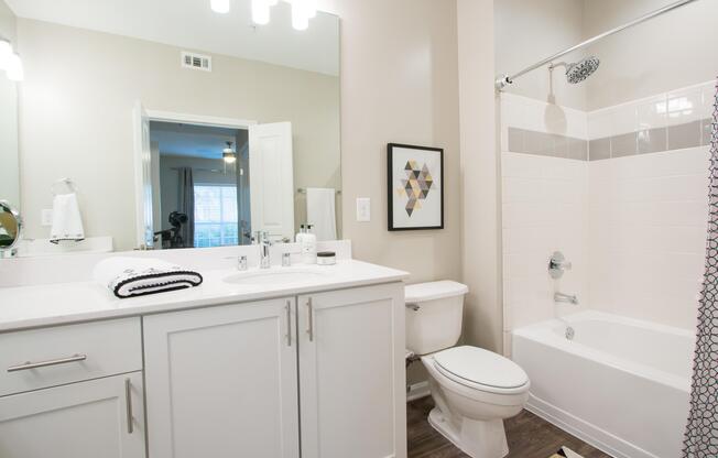 bathroom with White cabinets and white counters