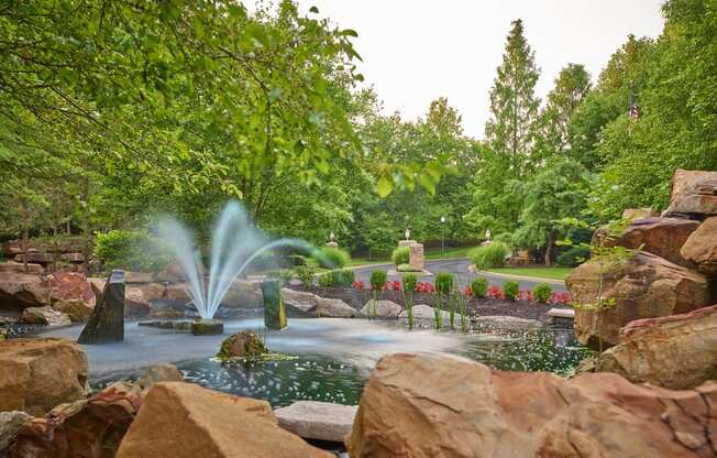 a water fountain in the middle of a pond