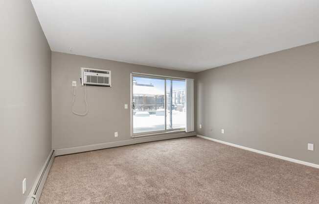 an empty living room with a large window. Roseville, MN Rosedale Estates
