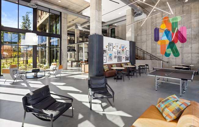 the lobby of a building with a ping pong table and chairs