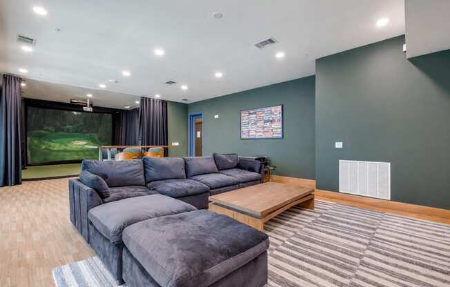 A living room with a grey sofa and a wooden coffee table.