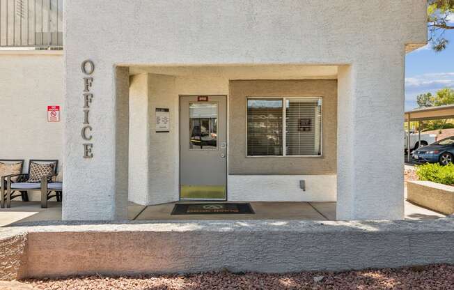 a white building with a glass door and a sign on the side of it