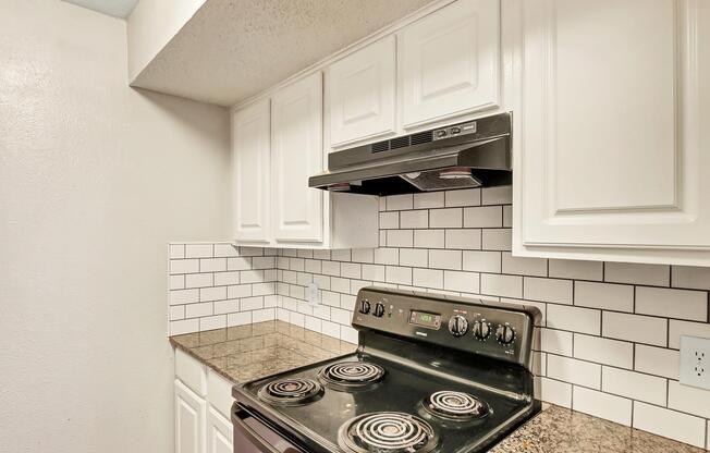 a stove top oven sitting inside of a kitchen