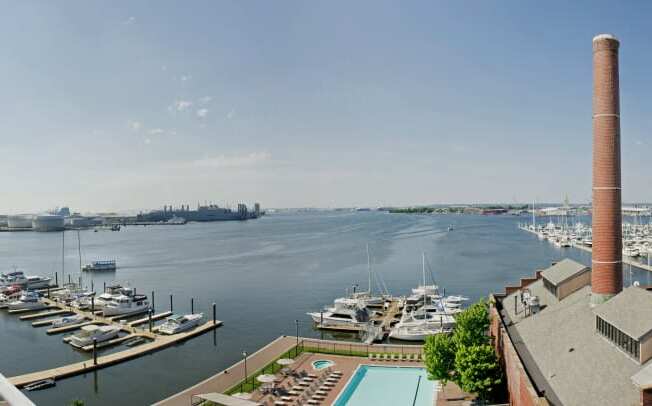 a view of the harbor from a building with a pool and boats in the water at Tindeco Wharf, Maryland