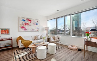 a living room with a couch and a large window at Sinclaire on Seminary, Alexandria, VA