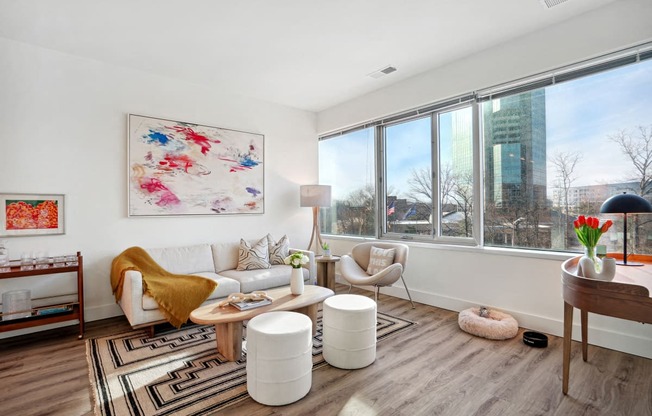 a living room with a couch and a large window at Sinclaire on Seminary, Alexandria, VA