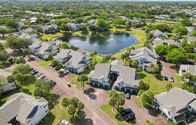 an aerial view of a neighborhood with houses and a lake