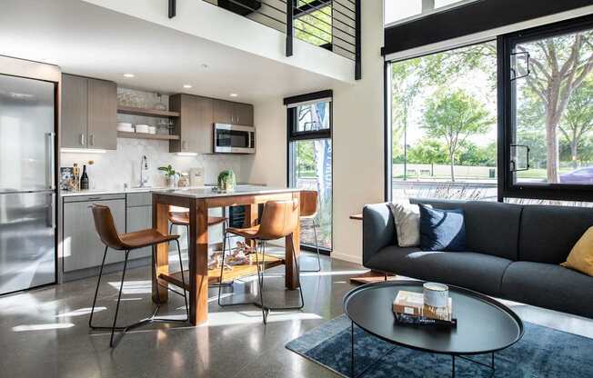 A modern kitchen with a dining table and chairs.