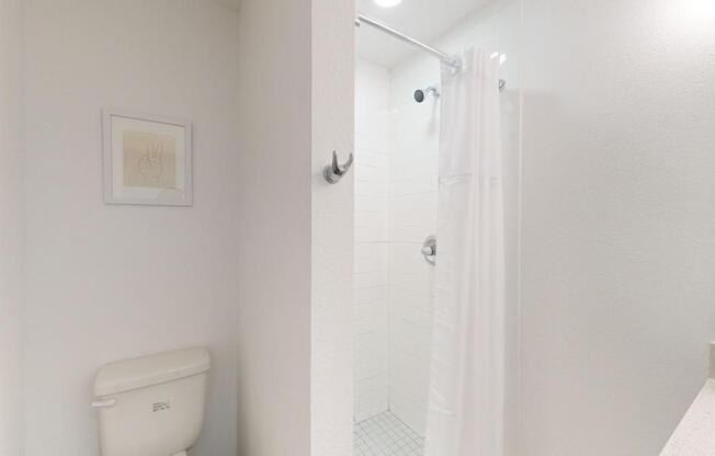 A white toilet is in a small bathroom.