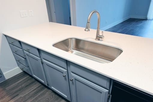 an empty kitchen counter with a sink and a faucet