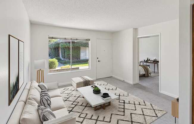 Model Living Room with Carpet and Window View at Walnut Creek Apartments located in Walnut Creek, CA.