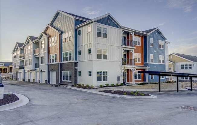 a row of townhomes with a parking lot in front of them