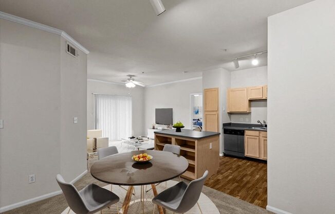 a dining room and kitchen with a table and chairs