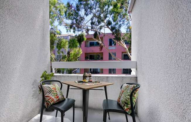 a balcony with two chairs and a table