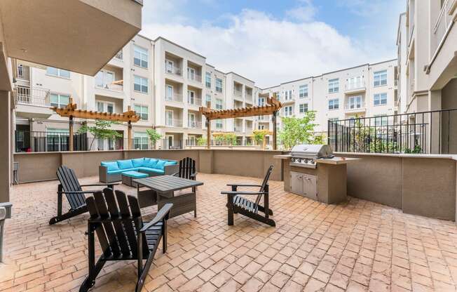 Spacious Patio With Sitting Arrangements with BBQ at Residences at 3000 Bardin Road, Grand Prairie, TX, Texas