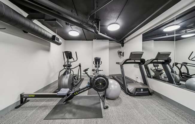 Fitness center with free weights and strength-training equipment at River 595