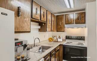 A kitchen with wooden cabinets and a white fridge.