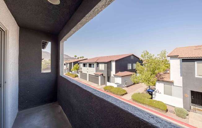 a balcony with a view of some houses and a street