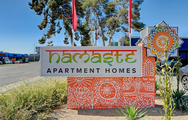 A sign for Bacaste Apartment Homes is displayed in front of a building.