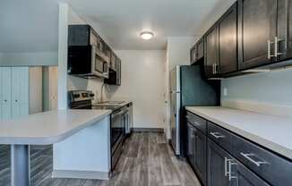 a kitchen with brown cabinets and white countertops